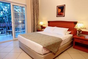 a bedroom with a bed and a large window at Grand Yazici Club Turban Termal in Marmaris