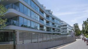 a large building with lots of windows on a street at VacationClub – Dune B Apartament 3.22 in Mielno
