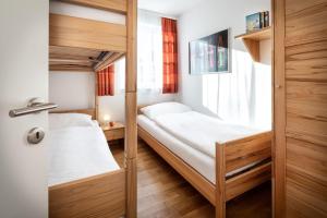 a bedroom with two bunk beds and a window at Fewo-Obertauern Alps in Obertauern