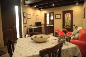 a dining room with a table with a bowl on it at Dimore di Lecce - I Figuli in Lecce