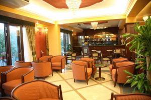 a restaurant with chairs and tables and a bar at Agostiniana Hotel in Forza dʼAgro