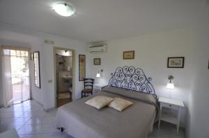 a bedroom with a bed with two pillows on it at Villa Eva in Anacapri