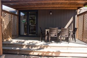 eine Holzterrasse mit einem Tisch und Stühlen darauf in der Unterkunft Camping Armanello in Benidorm