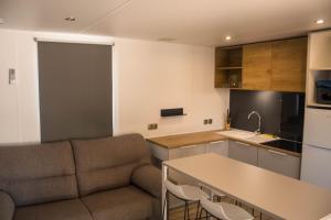 a living room with a couch and a kitchen at Camping Armanello in Benidorm