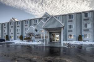 a large building with a parking lot in front of it at Quality Inn in Mount Pleasant