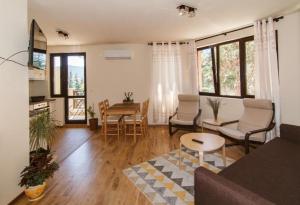a living room with a couch and a table at Bendida Apartments in Velingrad