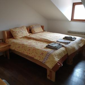 a bedroom with a large bed with a wooden frame at Villa Lake Palace in Berovo