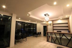 a living room with a table and a dining room at Somsamai Style Apartment in Khon Kaen