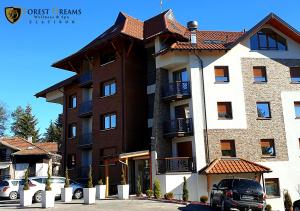 a large apartment building with a car parked in front of it at Forest Dreams in Zlatibor