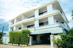 a large white building with a balcony at N.P. Apartment in Narathiwat