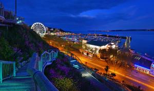 a view of a city at night with a ferris wheel at Newton House in Torquay