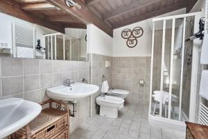 a bathroom with a sink, toilet and tub at Rouge Hotel International in Milano Marittima