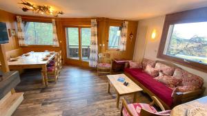 a living room with a couch and a table at Chalets de Julie in Megève