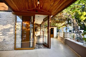 an open entrance to a house with glass doors at Barby Butik Otel in Kemer