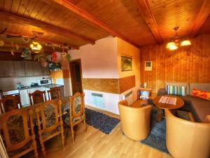 eine Küche und ein Wohnzimmer mit einem Tisch und Stühlen in der Unterkunft Chata Zuzana in Terchová
