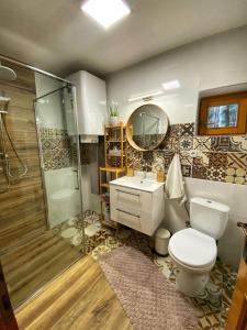 a bathroom with a toilet and a shower and a sink at Chata Zuzana in Terchová