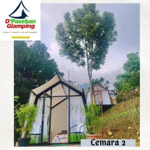 a gazebo greenhouse with a tree in the background at D'Paseban Glamping in Bogor