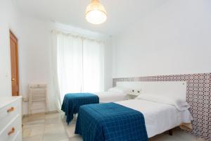 Letto o letti in una camera di BOHEMIA SANLUCAR