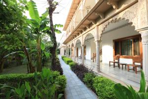 Hotel Sunbird في بهاراتبور: ساحة مبنى به اشجار ونباتات