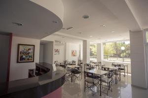 a restaurant with tables and chairs and a large window at Hotel Lavalle in General Lavalle