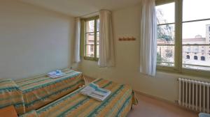 Cama o camas de una habitación en Apartamentos Montserrat Abat Marcet