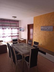 a dining room with a table and chairs at Private Apartments Nevena in Pamporovo +24 photos
