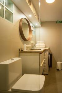 a bathroom with a toilet and a mirror at Txoko in Pamplona