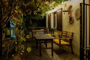 a patio with a table and chairs and vines at Casa Tomà in Masera