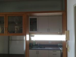 a kitchen with white cabinets and a sink and a light at Parana in Rosario