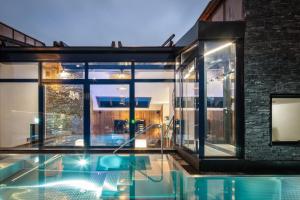 a house with a swimming pool in front of a building at Hotel-Gasthof Höttl in Deggendorf