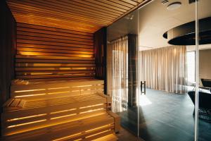 a sauna in a room with a glass wall at VILOTEL - Hotel & Restaurant in Oberkochen