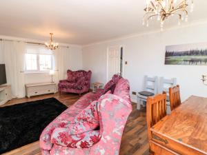 a living room with a couch and a table at Anvil Cottage in Northallerton