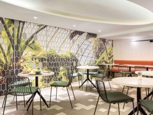 a rendering of a restaurant with tables and chairs at Aparthotel Adagio Paris Centre Tour Eiffel in Paris