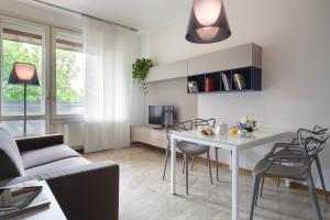 a living room with a white table and chairs at Contempora Apartments - Elvezia 8 - E22 in Milan