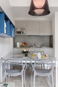 a kitchen with a table and chairs in a kitchen at Contempora Apartments - Elvezia 8 - E22 in Milan