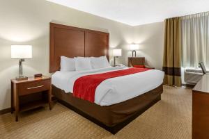 a hotel room with a large bed with a red blanket at Comfort Inn Valentine in Valentine