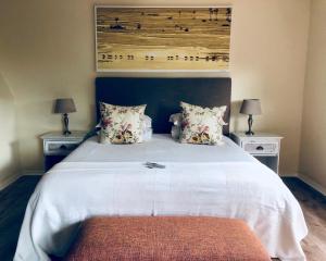 a bedroom with a large white bed with two night stands at Summit Place Guesthouse in Cape Town