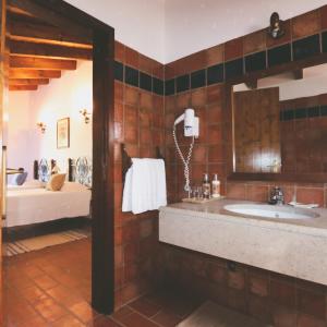 a bathroom with a sink and a mirror at Herdade Da Corte in Tavira