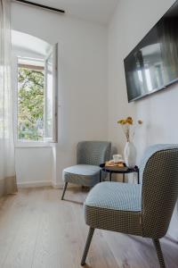 a living room with two chairs and a table at Inn by the River in Omiš