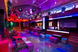 a nightclub with pink and purple lighting and tables and chairs at Iberostar Selection Royal El Mansour in Mahdia