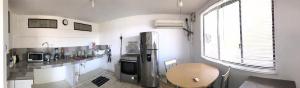 a kitchen with a stainless steel refrigerator and a window at Yaya's House in Posorja