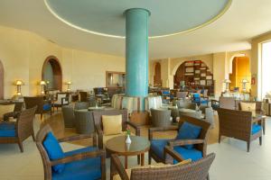 a restaurant with chairs and tables and a fireplace at Iberostar Selection Royal El Mansour in Mahdia