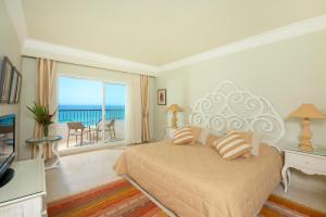 a bedroom with a bed with a view of the ocean at Iberostar Selection Royal El Mansour in Mahdia