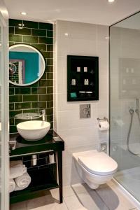 a bathroom with a toilet, sink, and bathtub at Hotel Indigo Newcastle, an IHG Hotel in Newcastle upon Tyne