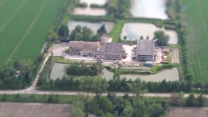 an aerial view of a large house with water at Agriturismo Lucchetta in Reggiolo