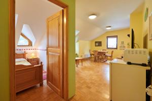 a room with a bed and a kitchen and a dining room at Eco Tourist Farm Ravnjak in Slovenj Gradec