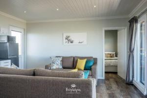 a living room with a couch and a bed at The Tin Shack in St Helena Bay