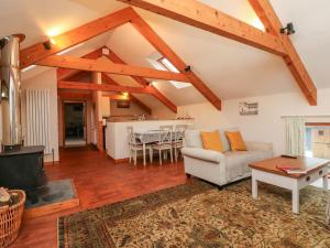 a living room with a couch and a table at Crooke Barn in Tiverton