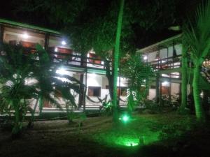 a building with green lights in front of it at night at Pousada Portal do Sol in Itacaré