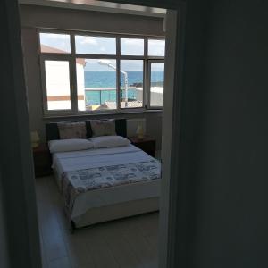 Schlafzimmer mit einem Bett und Meerblick in der Unterkunft Hotel Mudanya in Mudanya